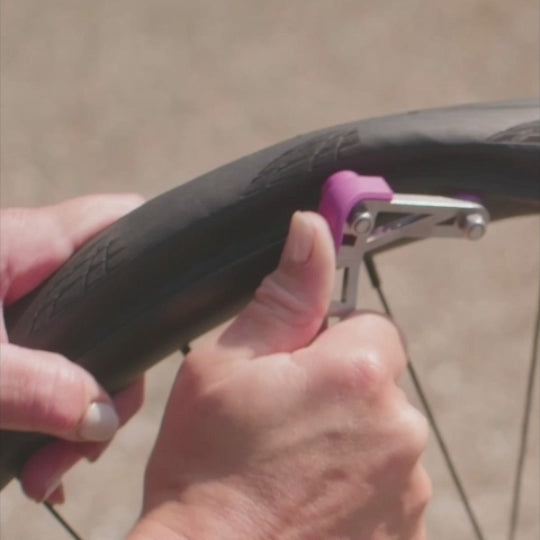 Lever up edge of tyre, push forwards a little and repeat until tyre is seated.